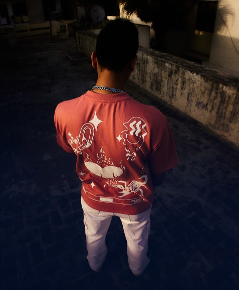 coral oversized crewneck sweatshirt with white back graphic of steaming bowl, flames and symbols, rear view model standing