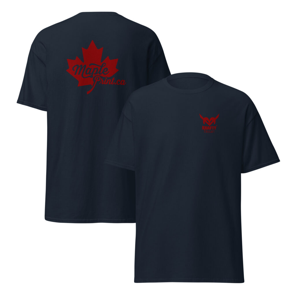 Unisex navy classic tee flat mockup showing KraftyBliss left-chest crest and large red Maple Print maple leaf on back